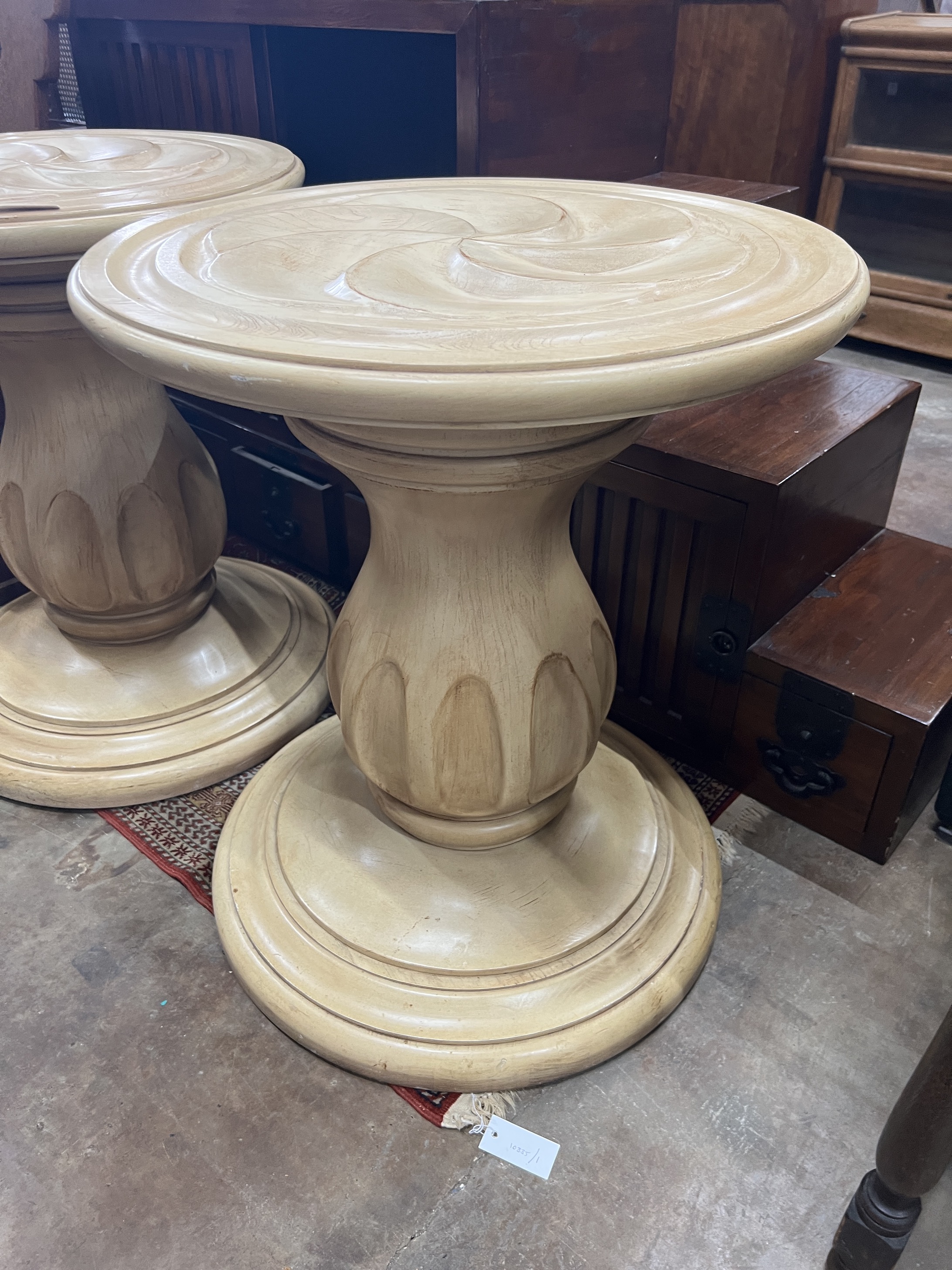 A pair of contemporary American circular carved wood centre tables, diameter 64cm, height 75cm